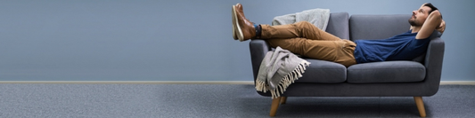 Man relaxing on a sofa at home